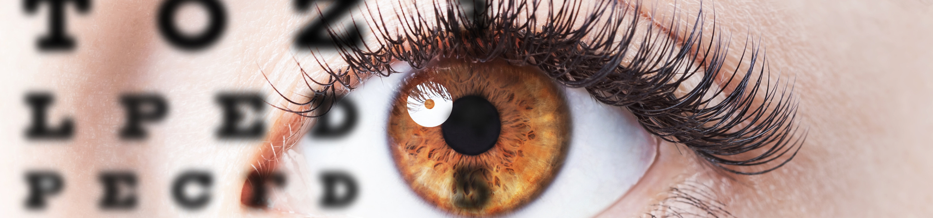 close up of hazel coloured with with eye chart overlay