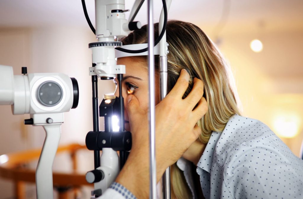 woman getting an eye exam from her optometrist