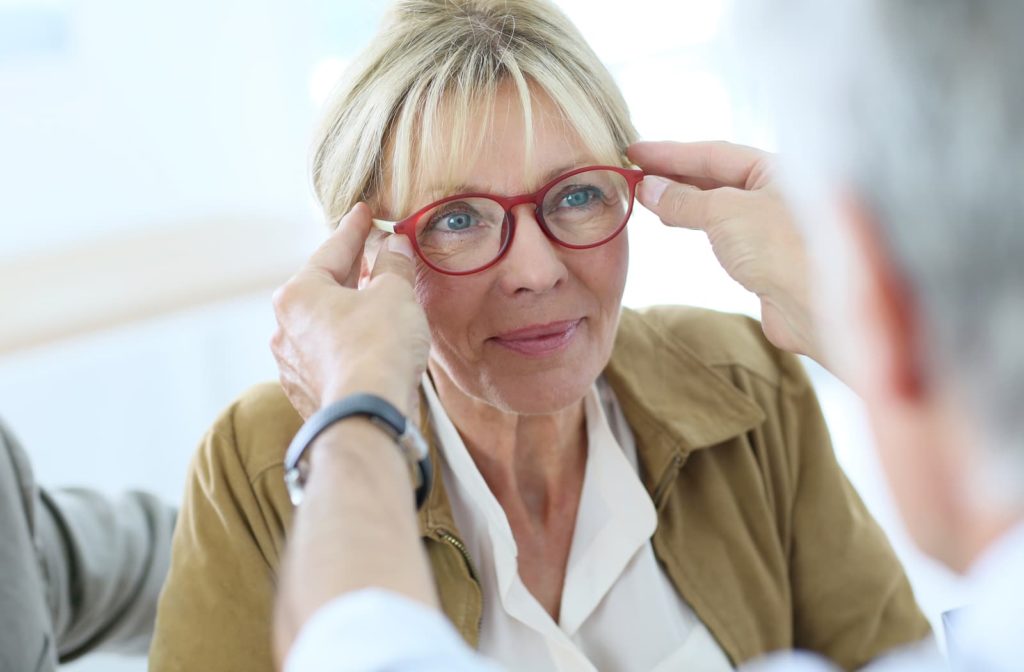 woman getting glasses from her optometrist