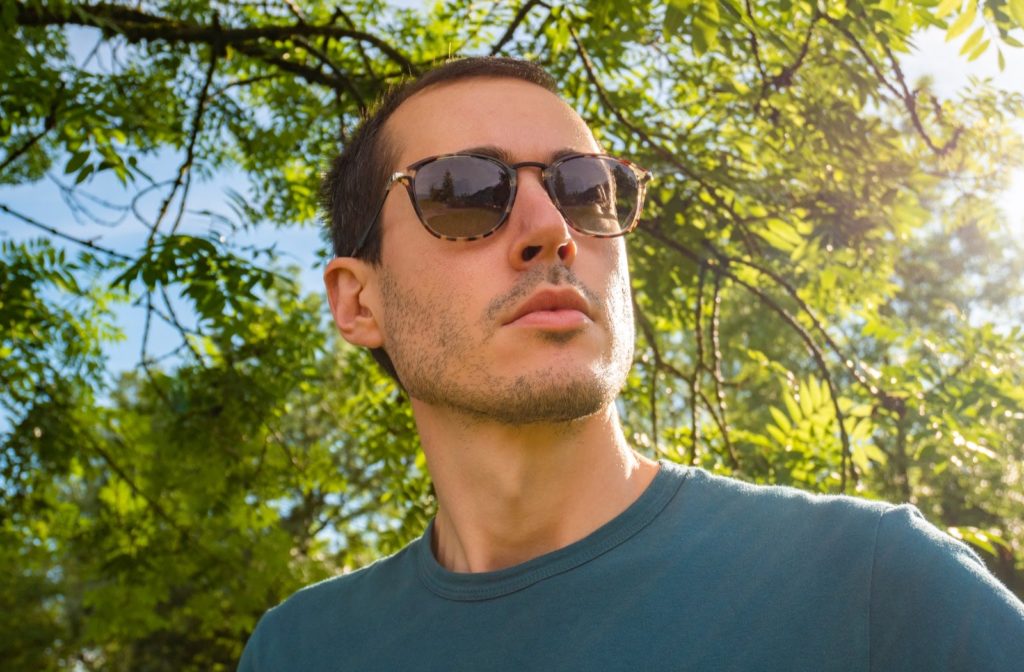 A man wearing polarized sunglasses on a bright and sunny day