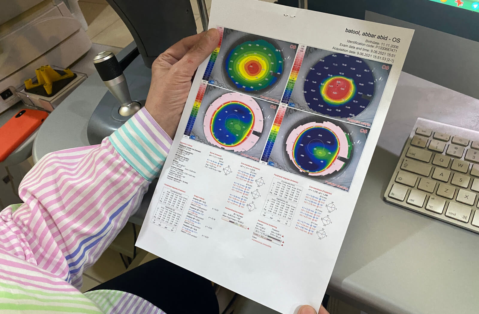 A hand of a male optometrist is reading the results from the Pachymetry test to diagnose glaucoma.