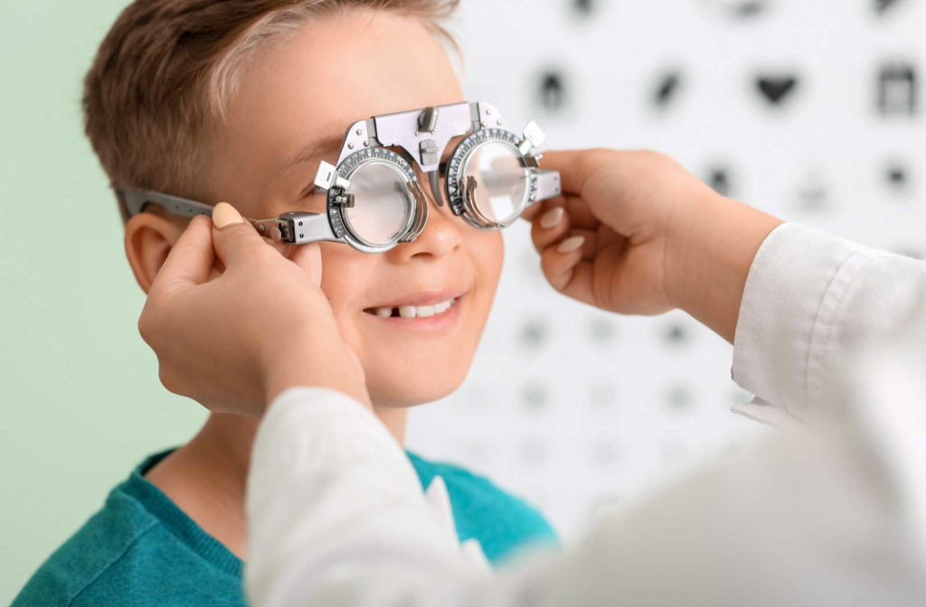 A young boy having his eyes assessed for vision problems during a routine eye exam