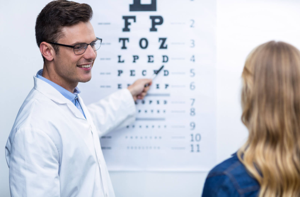 An optometrist conducting an eye exam on a female patient.