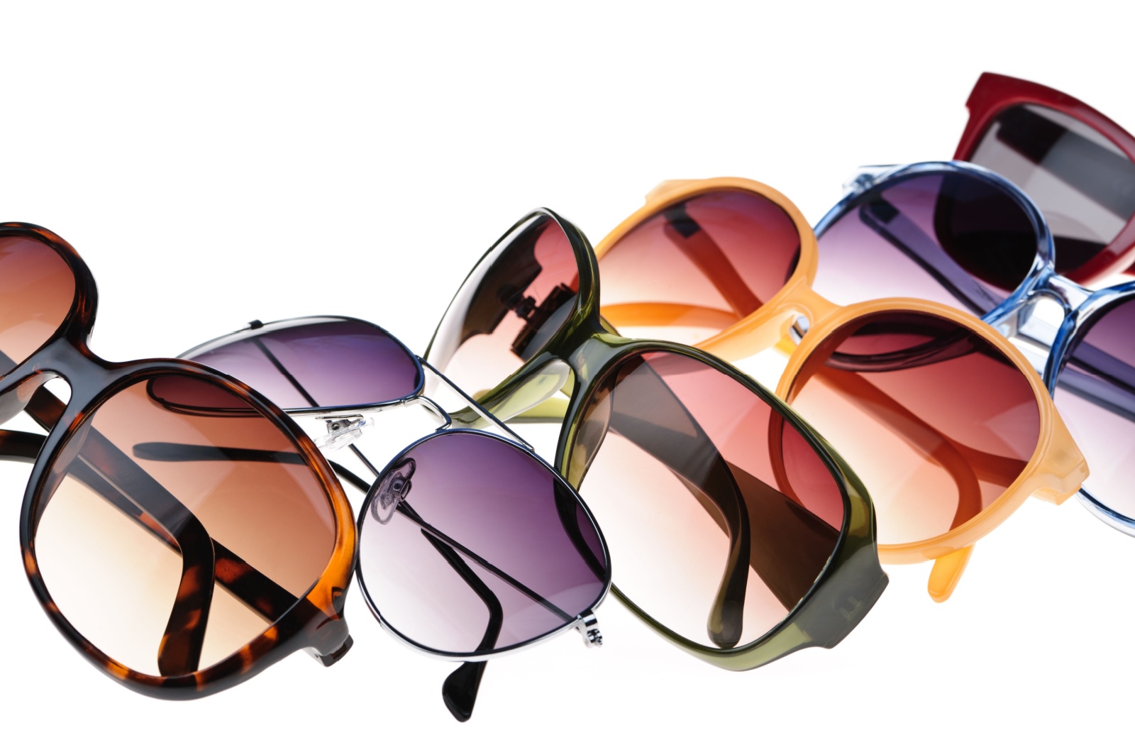 A diverse selection of sunglasses with different shapes, colours, and tints.
